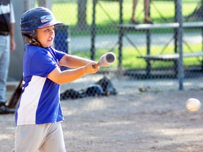 Andreas Harmer takes a mighty swing at this pitch during recent baseball action. ANDY BADER/MITCHELL ADVOCATE