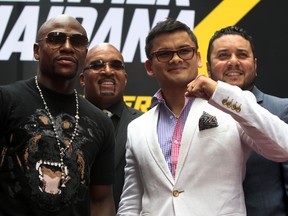 Floyd Mayweather Jr. and Marcos Maidana (right) promote their upcoming welterweight rematch during a press conference at Times Square. (Noah K. Murray-USA TODAY Sports)