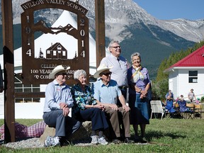Class photo. Classmates (left to right) John Sekella, Phyllis Moore and Hilton Pharis sit in front of a new sign during Willow Valley School’s centennial celebrations on Saturday, Sept. 6. Reeve Brian Hammond and former teacher Alta Pharis are standing. John Stoesser photos/QMI Agency