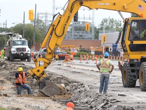 Road crews work on St. Matthews Avenue on Monday. Mayoral candidate Judy Wasylycia-Leis has suggested borrowing money to pay for road repairs is a good idea. (Brian Donogh/Winnipeg Sun)
