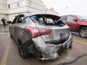 A burned out Hyundai Elantra is seen outside of the showroom at Capital GMC Buick at 97 Street and 34 Avenue as crews worked to clean up after an early morning fire that damaged the vehicle in Edmonton, Alta., on Monday, Sept. 8, 2014. A post on the dealership's website said that they expect the showroom will be open on Tuesday, Sept. 9. Police suspect arson. Ian Kucerak/Edmonton Sun/ QMI Agency