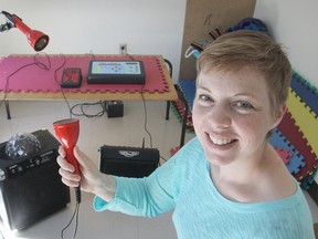 Shera Lumsden, founder of MusicMates, an organization that uses music to improve communication and social skills, shows their new SoundBeam, a unit which translates movement into sound. (Michael Lea/The Whig-Standard)
