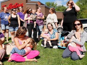 Moms breastfeed outside a Tim Hortons in Tweed, Ont., Sunday, Sept. 7, 2014. A mother said she was asked by a staff member to “cover up” while she was breastfeeding her child there last weekend.  Emily Mountney-Lessard/QMI Agency