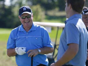 Coach Randy Carlyle (left) shares a laugh with defenceman Jake Gardiner at the Leafs and Legends Charity Golf Classic yesterday. Carlyle survived a house cleaning in the off-season. (Craig Robertson/Toronto Sun)