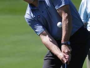 Defenceman Stephane Robidas chips during the Leafs and Legends Charity Golf Classic in Milton, Ont., on Monday. (Craig Robertson/Toronto Sun)