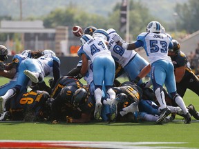 The Argos and Ticats in the Labour Day Classic — an “abysmal and unwatchable” game. (Jack Boland/Toronto Sun)