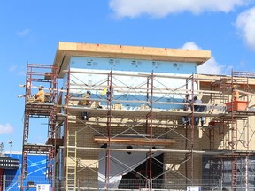 Gino Donato/The Sudbury Star
Bricklayers work on the front of the new LCBO at Silver Hills on Monday. The new store is slated to open this fall.