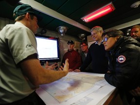 Prime Minister Stephen Harper (3rd R) is briefed about the search for the lost Franklin Expedition aboard the HMCS Kingston in Eclipse Sound, near the arctic community of Pond Inlet, Nunavut on August 24, 2014. (REUTERS/Chris Wattie)