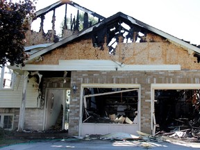 A Strathroy fire destroyed a Moffatt Lane home causing approximately $350-400,000 of damage after flames reached the roof. A woman and her dog, sole occupants at the time, were helped out of the home by police. As three fire stations responded they were impeded by parked cars, gawkers, and one fire truck by a passing train. Firefighters did contain the high flames to the property. ELENA MAYSTRUK/AGE DISPATCH/QMI AGENCY.