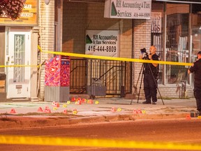 Forensic investigators gather evidence at the scene of a stabbing on Danforth Ave. on Tuesday, Sept. 9. (VICTOR BIRO/Special to the Toronto Sun)