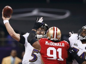 Baltimore Ravens quarterback Joe Flacco (5) passes under pressure from San Francisco 49ers defensive end Ray McDonald. (REUTERS/Mike Segar)