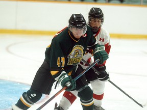 Wallaceburg Laker player Jordan Eagan battles for position with a Mooretown Flags player during a preseason game at Wallaceburg Memorial Arena on Wednesday, September  3, 2014. The Lakers begin their regular season with a home game against Amherstburg on Sept. 10.