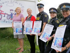From left to right: Adopt-A-Child volunteer Barb Lea, Belleville Police Service Cst. Anne Earle, Prince Edward OPP Cst. Anthony Mann, Central Hastings OPP Cst. Alana Deubel and Napanee OPP Cst. Stacey Cooper are gearing up for this year's Adopt-A-Child campaign. 
Belleville, Sept. 9, 2014. 
Emily Mountney-Lessard/The Intelligencer/QMI Agency