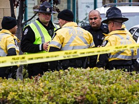 Police investigate at the parking lot in Namao Centre at 167 Avenue and 97 Street after a woman was seriously injured jumping out of a moving vehicle following an argument in Edmonton, Alta., on Tuesday, Sept. 9, 2014. Codie McLachlan/Edmonton Sun/QMI Agency