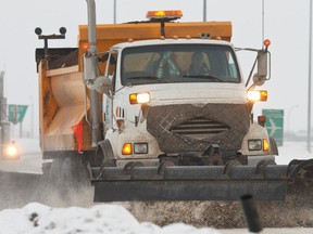A snow plow operator clears snow off of Highway 19 in Leduc County, Alta., on Monday, Dec. 30, 2013. Ian Kucerak/Edmonton Sun