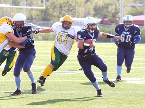 St. Benedict Bears quarterback Chase Pressacco, makes a run with the ball during high school football action against the Confederation Chargers last season.