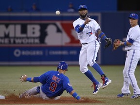 Jose Reyes of the Toronto Blue Jays turns a double play in the third inning as Javier Baez of the Chicago Cubs slides into second base on September 9, 2014 at Rogers Centre. (Tom Szczerbowski/Getty Images/AFP)