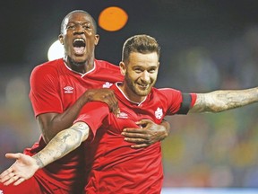 Canada’s  David Edgar celebrates his goal with Doneil Henry (left) during Tuesday night’s win over Jamaica at BMO Field. (CRAIG ROBERTSON/Toronto Sun)