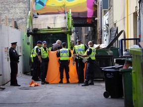 Police at the scene of a garbage truck fatality on Wednesday, Sept. 10, 2014. (ERNEST DOROSZUK/Toronto Sun)