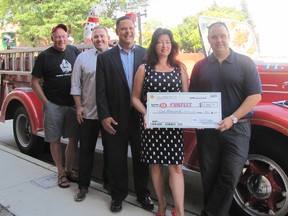FireFest is benefitting from a $1,000 donation this year from the Historic Downtown Chatham BIA. Standing with the cheque in front of a 1950 Mack firetruck are, from left, organizer Wes Thompson, sponsor Carson Warrener of the Downtown Chatham Centre, event organizer and co-chair Keith Chinnery, Nancy Labadie of the BIA and organizer/co-chair Brent DeNure.