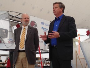 Barry Prentice, left, and Elmwood-Transcona MP Lawrence Toet attend a press conference Wednesday, Sept. 10, 2014 announcing the addition of a new solar panel at Buoyant Aircraft Systems International at the St. Andrews airport.