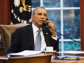U.S. President Barack Obama speaks on the phone with Saudi Arabia's King Abdullah from the Oval Office of the White House in Washington September 10, 2014.  REUTERS/Kevin Lamarque