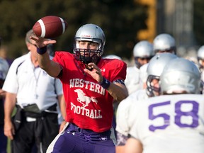 Mustangs quarterback Will Finch, the central figure in Western?s banzai (hurry-up) offensive sets, keeps his eyes on a snapped ball during practice this week. (CRAIG GLOVER, The London Free Press)