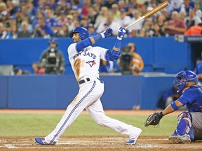 Jose Bautista launches his 200th Blue Jays home run on Monday night at the Rogers Centre against the Cubs. (AFP)