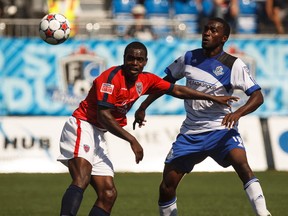 Edmonton forward Oluwatomiwo Ameobi (right) and Indy defender Fejiro Okiomah (left) eye an airbourne ball during a NASL soccer game between FC Edmonton and the Indy Eleven at Clark Stadium in Edmonton, Alta., on Sunday, July 27, 2014. The Eddies lost 0-1 in extra time. Ian Kucerak/Edmonton Sun/QMI Agency