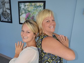 Colleague Kistin Taus (left) teaches Jennifer Michaud yoga at lunch. Exercise just ½ an hour a day can make a difference.