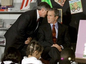 U.S. President George W. Bush listens as White House Chief of Staff Andrew Card informs him of a second plane hitting the World Trade Center while Bush was conducting a reading seminar at the Emma E. Booker Elementary School in Sarasota, Florida in this September 11, 2001 file photo. (REUTERS/Win McNamee/Files)