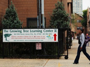A woman walks past The Growing Tree Learning Center II in Jersey City, New Jersey, September 11, 2014. (REUTERS/Eduardo Munoz)