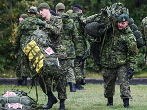 Soldiers set up for the start of the Mountain Man Challenge, which takes place on Thursday, in Hawrelak Park in Edmonton, Alta., on Wednesday, Sept. 10, 2014. Soldiers from Canadian Forces Bases Edmonton, Wainwright and Shilo will compete in the 50 kilometre challenge in the Edmonton River Valley. Codie McLachlan/Edmonton Sun