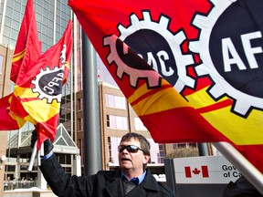 Oneil Carlier hands out flags outside of Canada Place during a Public Service Alliance of Canada, PSAC, demonstration in Edmonton, Alberta on Thursday, March 1, 2012.  
AMBER BRACKEN/EDMONTON SUN/QMI AGENCY