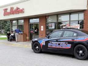 Chatham-Kent police canvassed a number of Blenheim Tim Hortons patrons as witnesses to a stabbing at the popular eatery at 10:30 a.m. Thursday. The suspect, who fled the scene, was apprehended shortly after. The victim is in stable condition. (Diana Martin/QMI Agency)