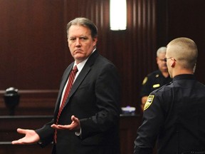 Michael Dunn (L) raises his hands in disbelief as he looks toward his parents after the verdicts were announced in his trial in Jacksonville, Florida in this February 15, 2014 file photo. The Florida jury in the loud music murder trial of Michael Dunn voted 9-3 in favor of convicting the 47-year-old software engineer of first-degree murder, a member of the panel said in a television interview.    REUTERS/Bob Mack/Florida Times-Union/Pool/Files