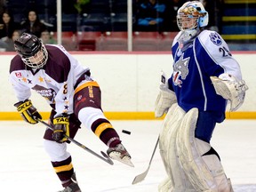 Alexandre Brisson, of the Timmins Majors, deflects a shot fired at Sudbury Nickel Capital Wolves goalie Mackenzie Savard during playoff action at McIntye Arena last March. Savard signed with the OHL's Mississauga IceDogs on Thursday.