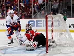 Josh Bailey of the New York Islanders scores on a spin-o-rama in the shootout against Martin Brodeur of the New Jersey Devils at the Prudential Center on April 11, 2014. (Bruce Bennett/Getty Images/AFP)