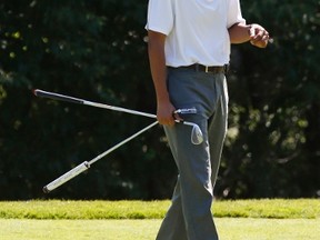 U.S. President Barack Obama laughs while playing a round of golf at Farm Neck Golf Club in Oak Bluffs on Martha's Vineyard, Massachusetts August 9, 2014.  The Obama family is on a two-week vacation on the Vineyard. REUTERS/Kevin Lamarque