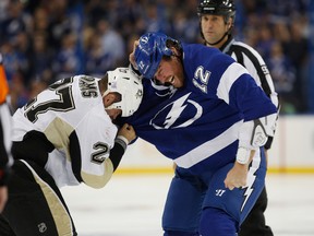 Ryan Malone of the Tampa Bay Lightning fights with Craig Adams of the Pittsburgh Penguins during the first period at Tampa Bay Times Forum on October 12, 2013. (Scott Iskowitz/Getty Images/AFP)