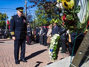 Edmonton Fire Chief Ken Block takes a moment after laying a wreath during the Firefighter's Memorial in Edmonton, Alta., on Thursday, Sept. 11, 2014. Codie McLachlan/Edmonton Sun