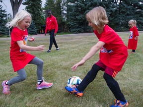 National team player Sura Yekka plays a fun game of soccer with members of the Watt family. (Ian Jackson, Canada Soccer)