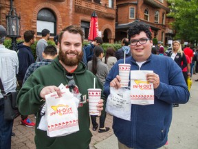 Daniel Zimmerman (left) and Andrew Poczkalski drove from Buffalo, N.Y. and waited three hours outside of Italian restaurant Osteria dei Ganzi for a 'pop up shop' of In-N-Out Burger on Jarvis St. in Toronto Thursday September 11, 2014. (Ernest Doroszuk/Toronto Sun)