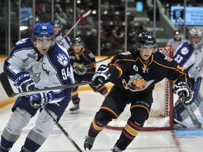 Brody Silk of the Sudbury Wolves tangles with Matthew Kreis of the Barrie Colts during first period preseason action Thursday at Barrie Molson Centre.
