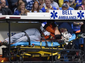 Miami Marlins right fielder Giancarlo Stanton is carted off the field after getting hit by a pitch in the fifth inning against the Milwaukee Brewers at Miller Park on September 11, 2014. (Benny Sieu/USA TODAY Sports)