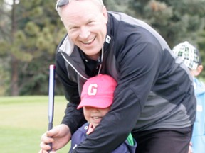 Stony Plain golf pro Chris Toth gives a youngster a helping hand with some swing mechanics during the course’s annual Junior/Junior golf lessons, held earlier this summer. - Gord Montgomery, Reporter/Examiner