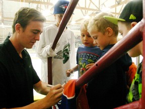 Ben Scrivens, the rising NHL star goaltender for the NHL’s Edmonton Oilers, takes some time to sign autographs for young fans at the game. - Gord Montgomery, Reporter/Examiner