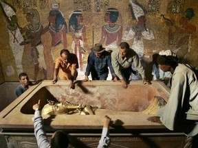 Zahi Hawass (back, 3rd L), head of the High Council for Antiquities, supervises the removal of the mummy of King Tutankhamen from his stone sarcophagus in his underground tomb in the Valley of the Kings in Luxor in this November 4, 2007 file photo. Reuters/Ben Curtis/Pool/Files