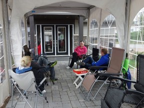 Ashley Lamothe, centre, is first in line among a group of would-be home buyers camping out Friday for a new Minto home on a ravine lot going on sale Saturday.MEGAN GILLIS/OTTAWA SUN