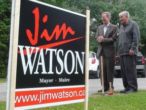 Mayor Jim Watson prepares to hammer an election sign into the ground at philanthropist Dave Smith's home on Island Park Dr. on Friday, Sept. 12, 2014. 
Jon Willing/Ottawa Sun/QMI Agency